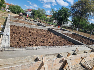 Démontage des poutres de fondation, application d'un revêtement bitumineux et remblai de terre thumbnail