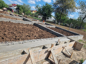 Démontage des poutres de fondation, application d'un revêtement bitumineux et remblai de terre thumbnail