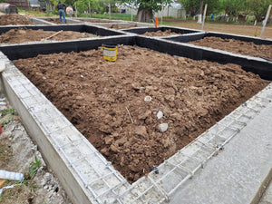 Démontage des poutres de fondation, application d'un revêtement bitumineux et remblai de terre thumbnail