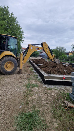 Démontage des poutres de fondation, application d'un revêtement bitumineux et remblai de terre thumbnail