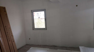 Ponçage des murs, des plafonds et application d'une couche d'apprêt avec du mastic pour le projet de maison. thumbnail