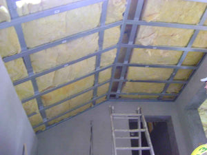 Aménagement des combles de 120 mètres carrés réalisé avec du plâtre ignifuge de couleur rouge thumbnail
