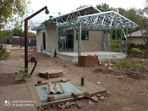 Revêtement extérieur en fibrociment pour une maison métallique de plain-pied avec terrasse couverte thumbnail