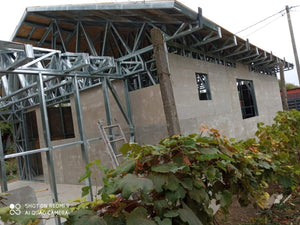 Revêtement extérieur en fibrociment pour une maison métallique de plain-pied avec terrasse couverte thumbnail