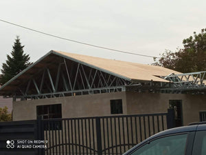 Revêtement extérieur en fibrociment pour une maison métallique de plain-pied avec terrasse couverte thumbnail