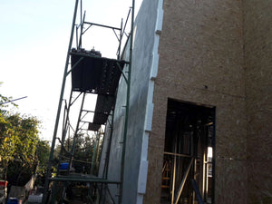 Projet de maison à un stade où l'enduit est appliqué sur les façades thumbnail