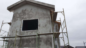 Projet de maison à un stade où l'enduit est appliqué sur les façades thumbnail